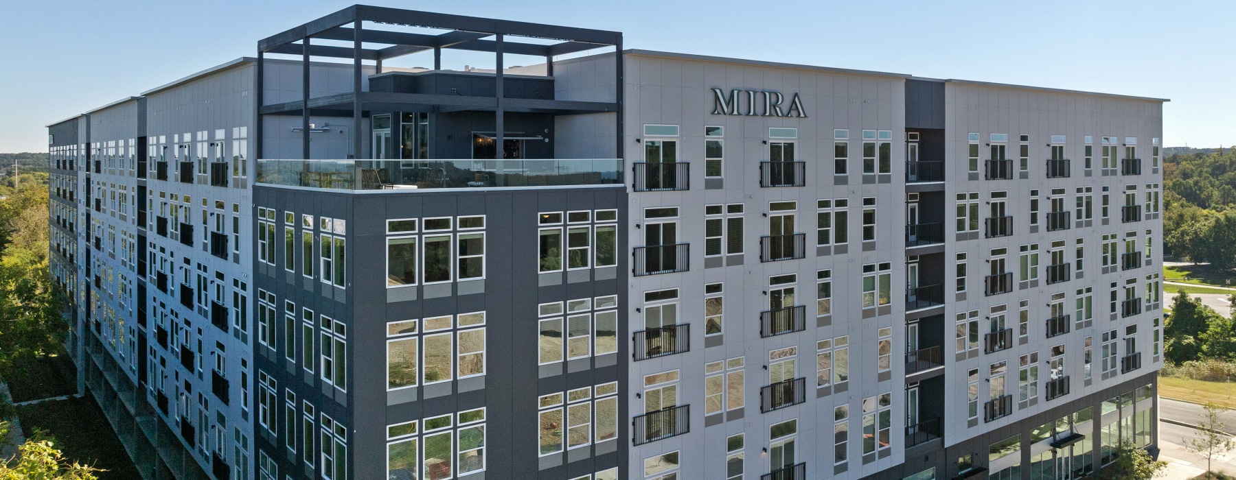 Exterior image of Mira Raleigh Apartments located in Downtown Raleigh with a top floor lounge on a mid-rise apartment building