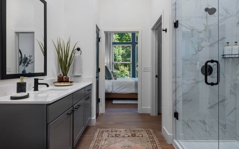 bathroom vanity with quartz countertop vanity and  gray cabinets and a frameless glass tiled shower