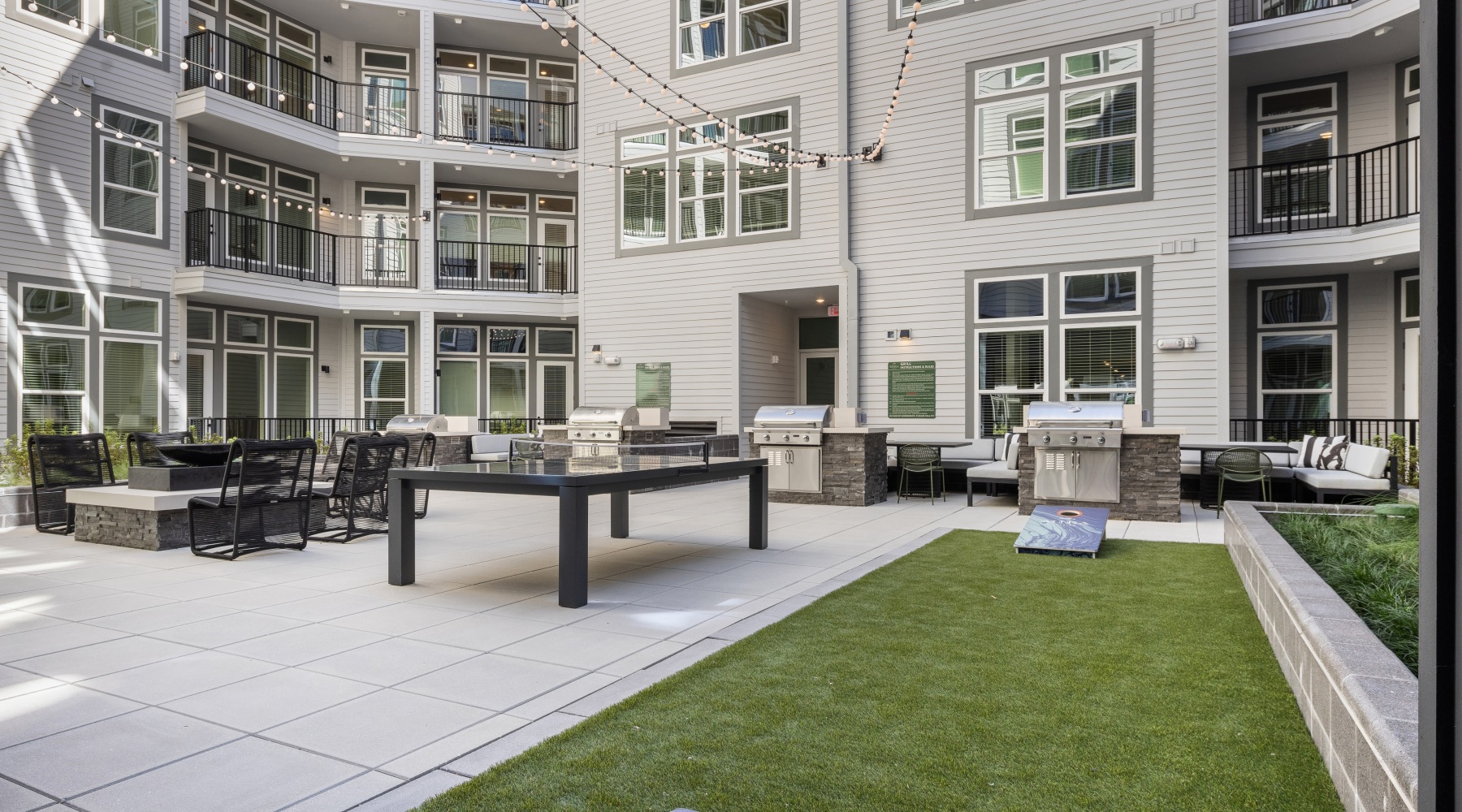 Game Lawn with cornhole boards and courtyard