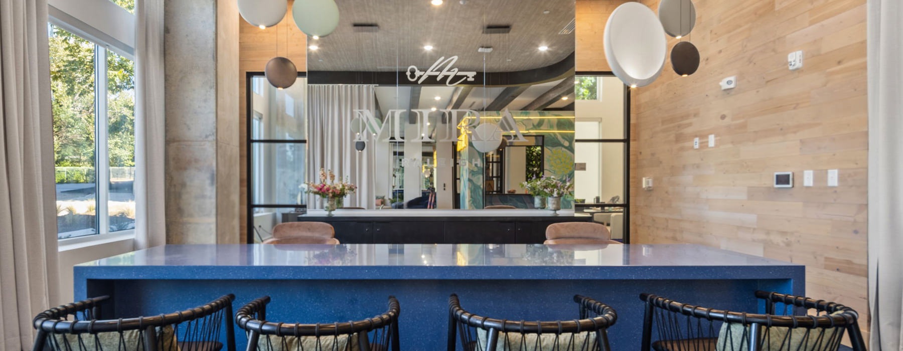 a seating area with a large engraved mirror